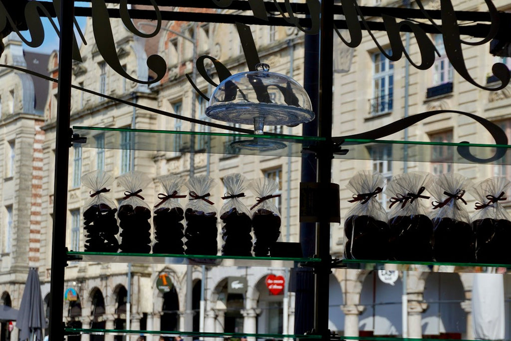 Glass shelves display chocolates in a storefront, echoing the taste of France lingerie market.